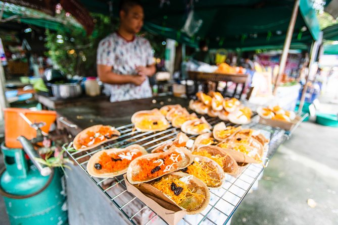 Bangkok Floating Market & Boat Ride to an Orchid Farm - Eating at the market with a guide
